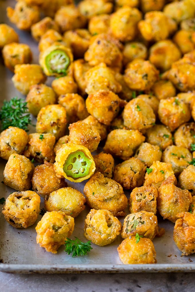 Fried Okra Recipe #okra #appetizer #sidedish #uzhal Fried okra on a sheet pan, garnished with chopped parsley.