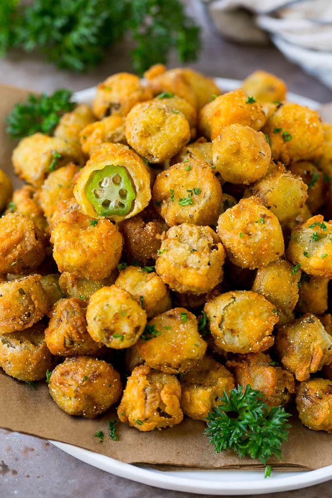 Fried Okra Recipe #okra #appetizer #sidedish #uzhal A serving plate of fried okra garnished with parsley.