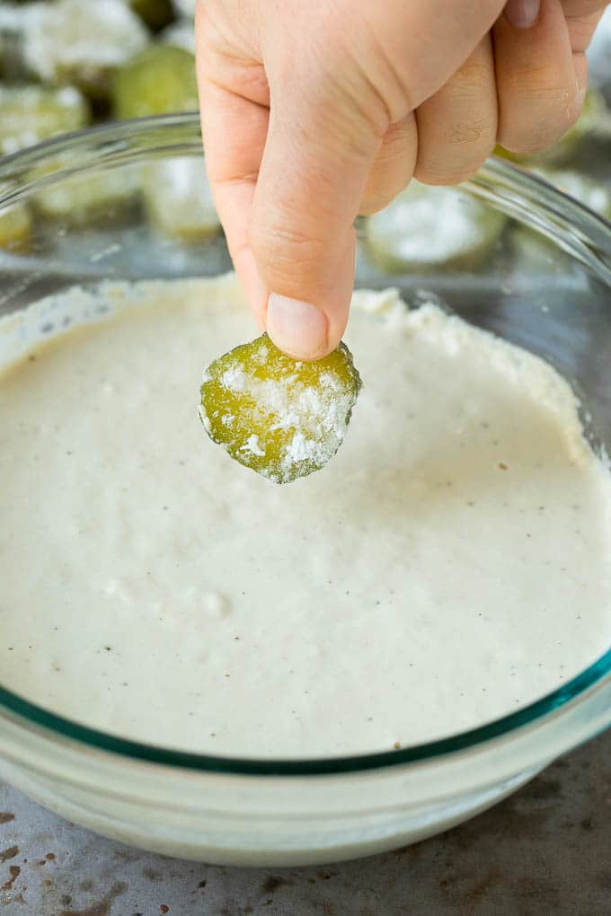 Fried Pickles Recipe #pickles #appetizer #snack #uzhal A slice being dipped into a bowl of beer batter.