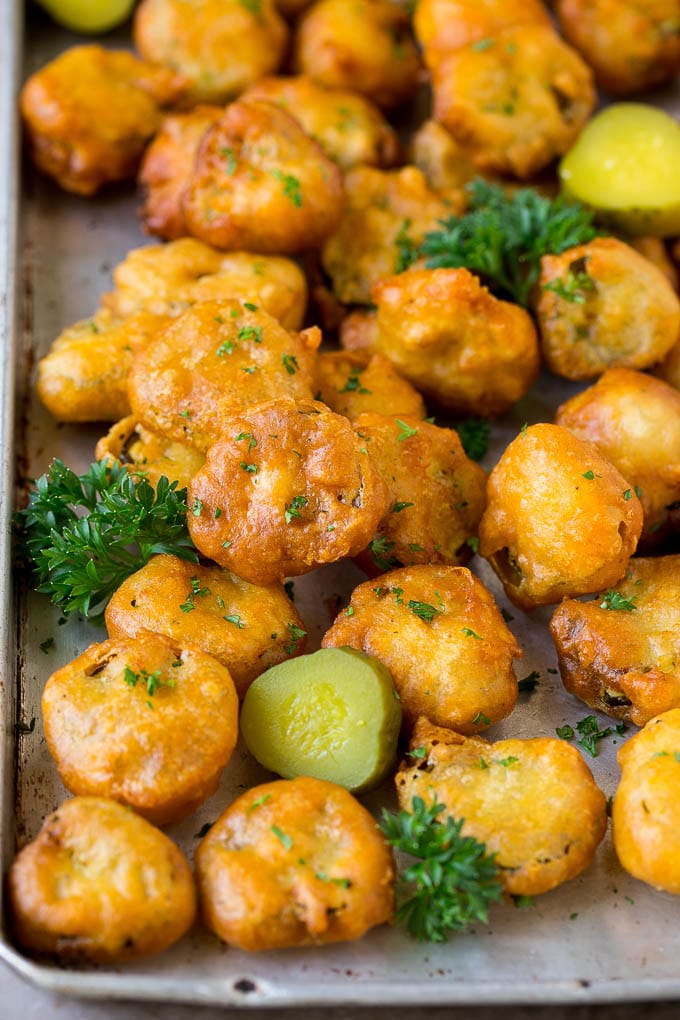 Fried Pickles Recipe #pickles #appetizer #snack #uzhal Fried pickles on a sheet pan, garnished with parsley.