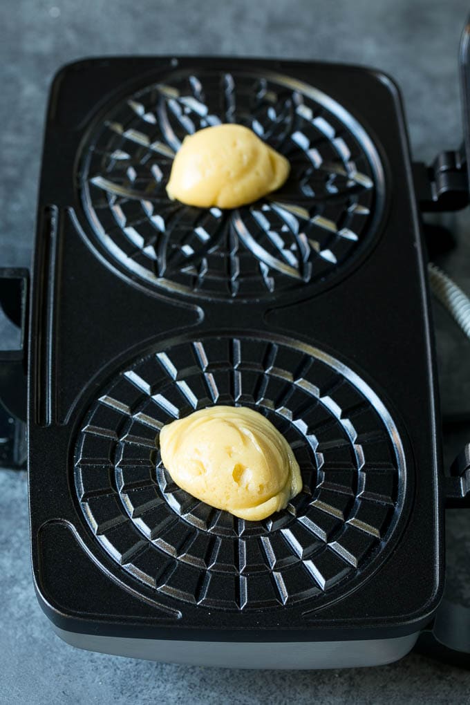Pizzelle Cookies Recipe #cookies #baking #dessert #christmas #uzhal Dollops of dough in a cookie iron.