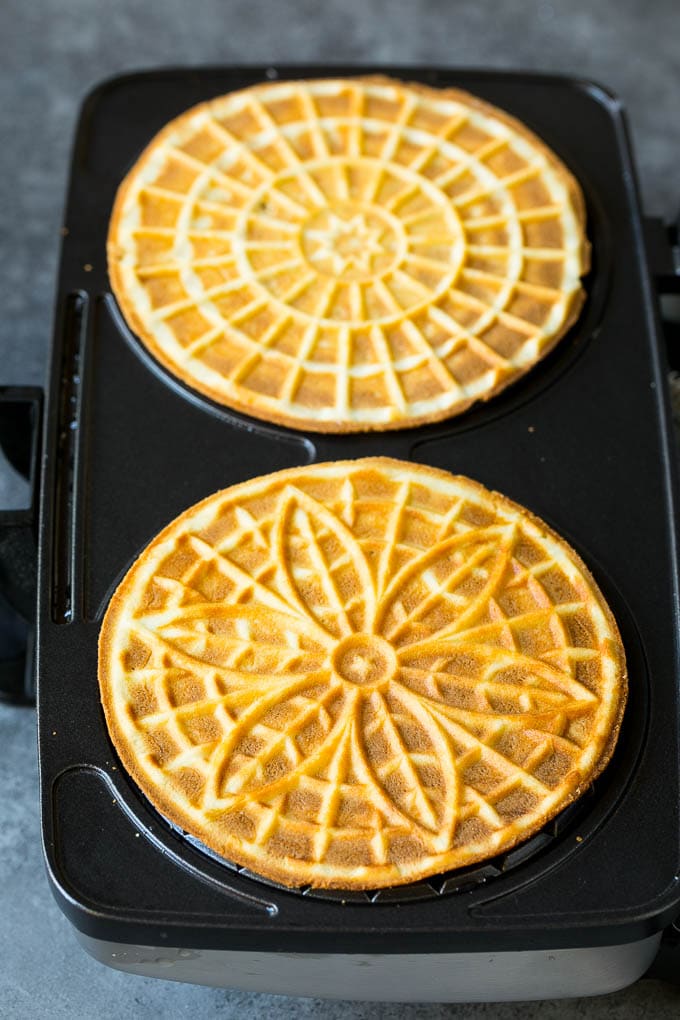 Pizzelle Cookies Recipe #cookies #baking #dessert #christmas #uzhal Baked cookies inside a pizzelle iron.