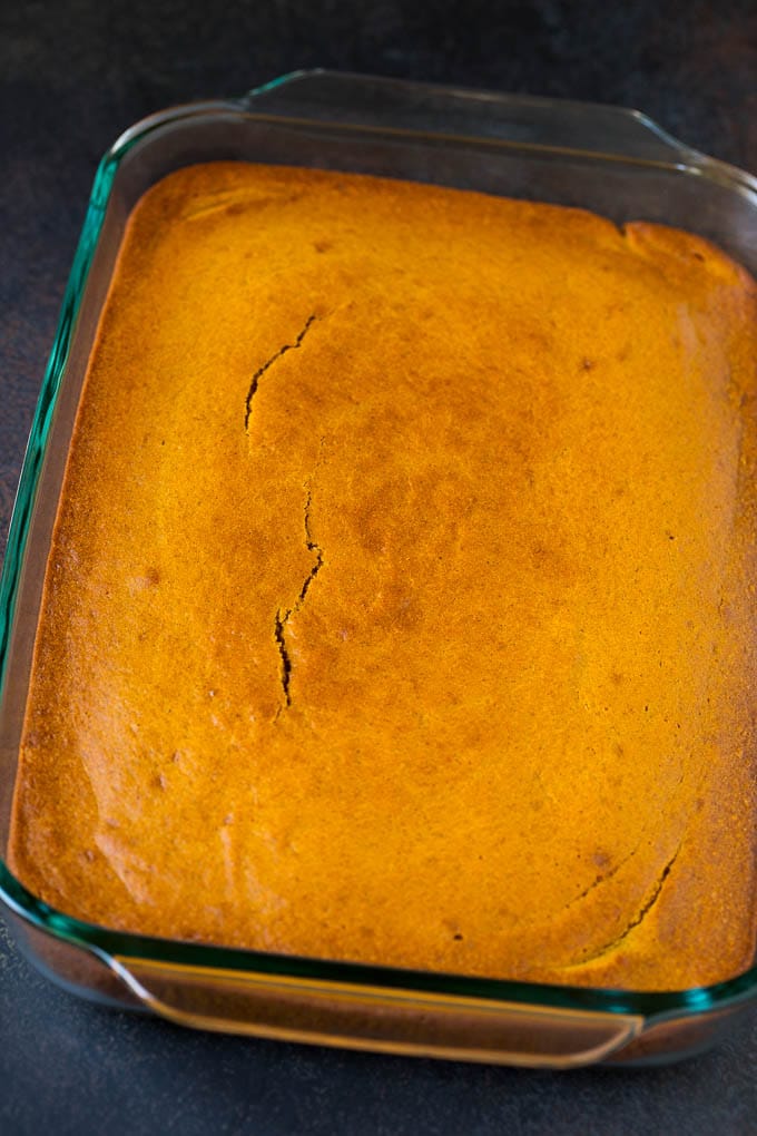 Pumpkin Cake Recipe | Pumpkin Spice Cake #cake #pumpkin #dessert #baking #fall #thanksgiving #uzhal A baked base in a glass dish ready for frosting.