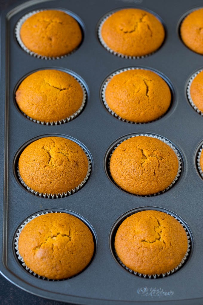 Pumpkin Cupcakes Recipe | Pumpkin Cake #cake #cupcakes #pumpkin #frosting #baking #fall #thanksgiving #uzhal Baked cupcakes in a muffin tin.