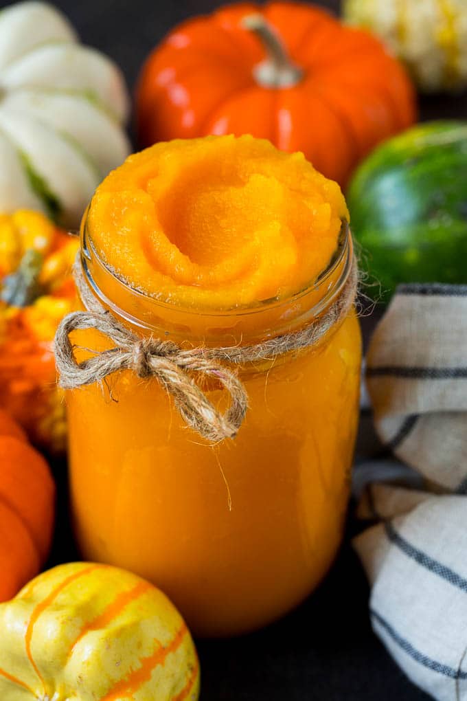 Pumpkin Puree Recipe #pumpkin #baking #fall #thanksgiving #uzhal A jar of pumpkin puree surrounded by fall produce.
