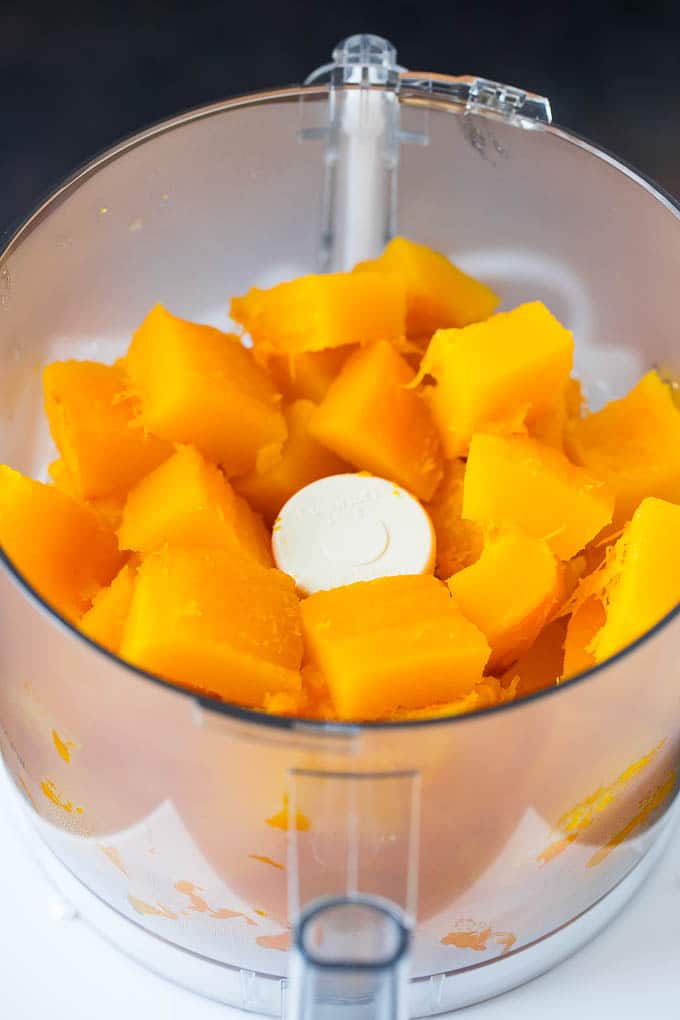 Pumpkin Puree Recipe #pumpkin #baking #fall #thanksgiving #uzhal Cubes of pumpkin in a food processor.