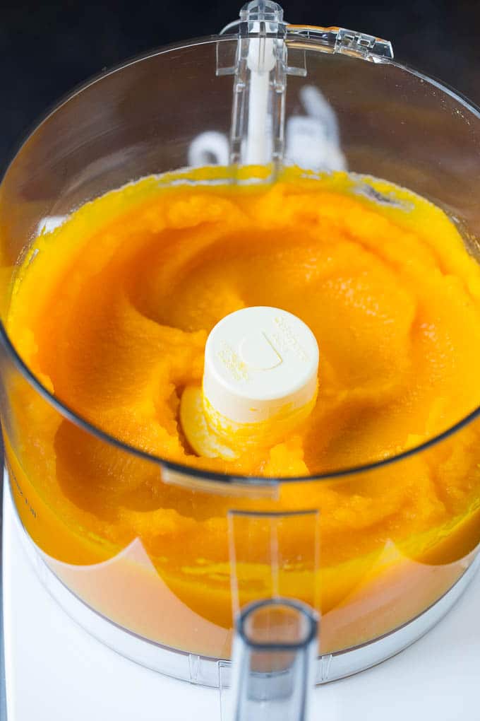 Pumpkin Puree Recipe #pumpkin #baking #fall #thanksgiving #uzhal Pureed pumpkin in a food processor.