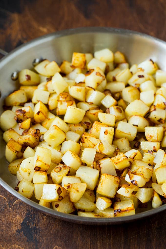 Corned Beef Hash Recipe #hash #cornedbeef #stpatricksday #breakfast #brunch #potatoes #uzhal Sauteed potatoes in a skillet.