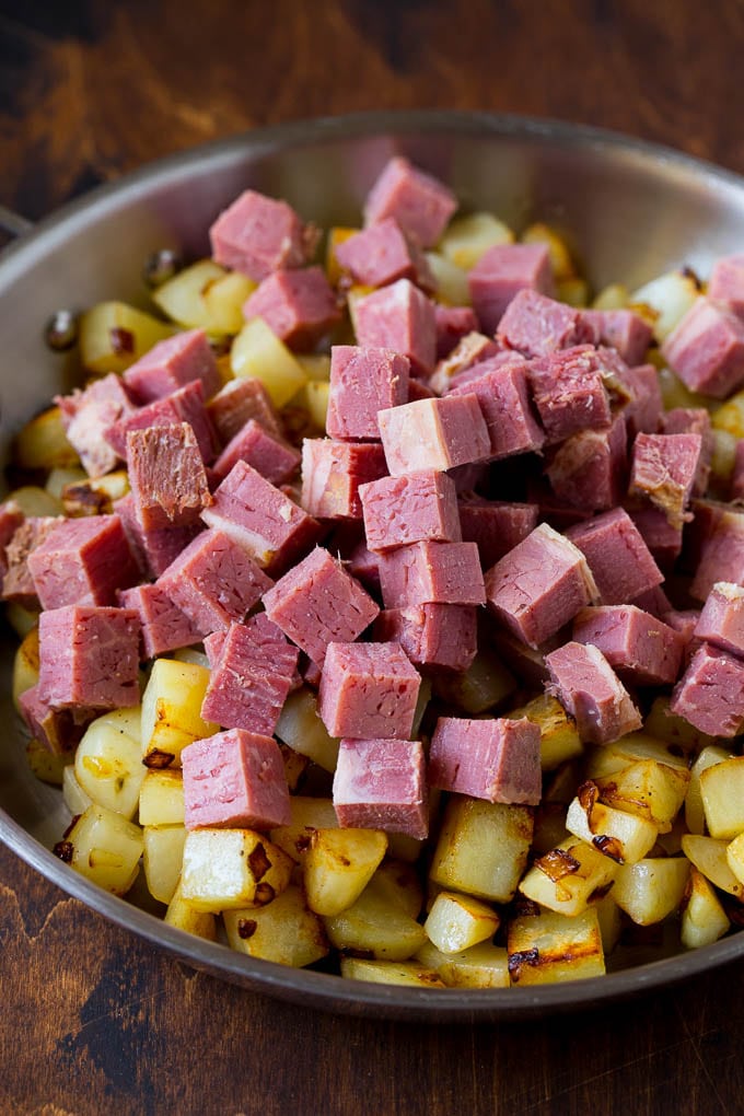 Corned Beef Hash Recipe #hash #cornedbeef #stpatricksday #breakfast #brunch #potatoes #uzhal Cubed corn beef on top of cooked potatoes.