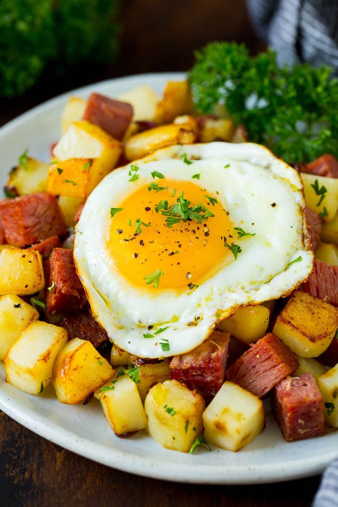 Corned Beef Hash Recipe #hash #cornedbeef #stpatricksday #breakfast #brunch #potatoes #uzhal A plate of corned beef hash topped with a fried egg.