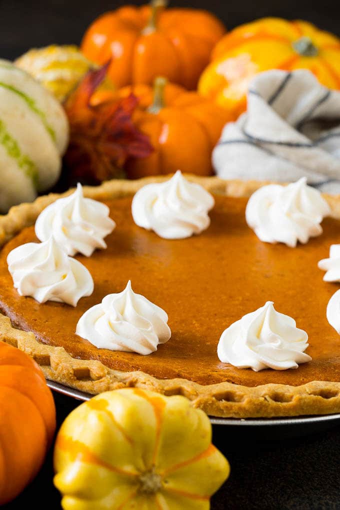 Homemade Pumpkin Pie Recipe | Pumpkin Pie #pie #pumpkin #baking #thanksgiving #fall #dessert #uzhal Homemade pumpin pie topped with rosettes of whipped cream.