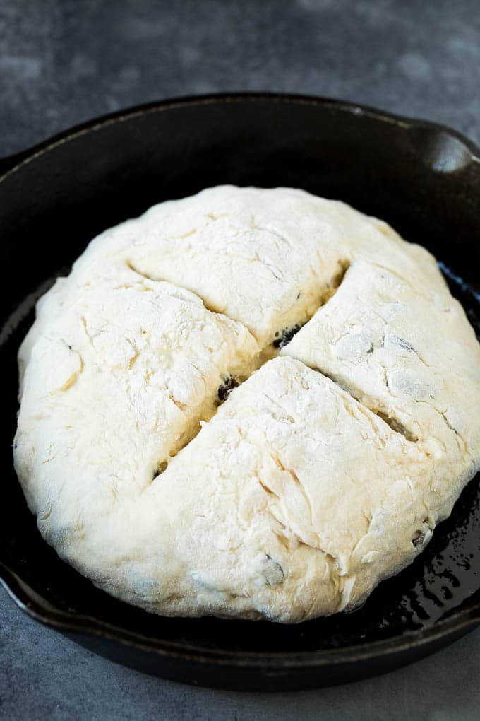 Irish Soda Bread Recipe #bread #baking #stpatricksday #sidedish #uzhal A shaped loaf of soda bread in a skillet.
