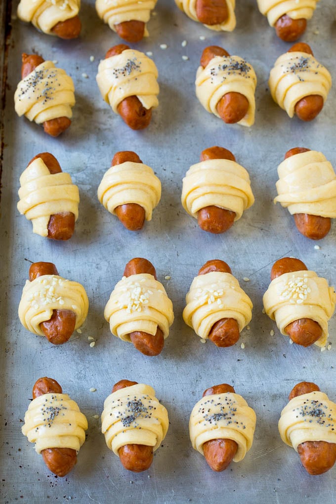 Pigs in a Blanket Recipe #hotdogs #appetizer #snack #comfortfood #uzhal Mini hot dogs wrapped in crescent dough and topped with seeds.