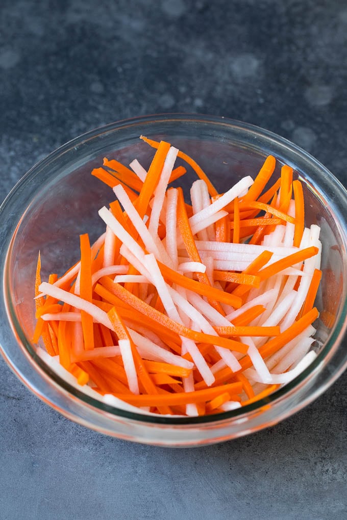 Bahn Mi Sandwich Recipe #sandwich #pork #lunch #dinner #uzhal Shredded carrots and daikon radish in a bowl.