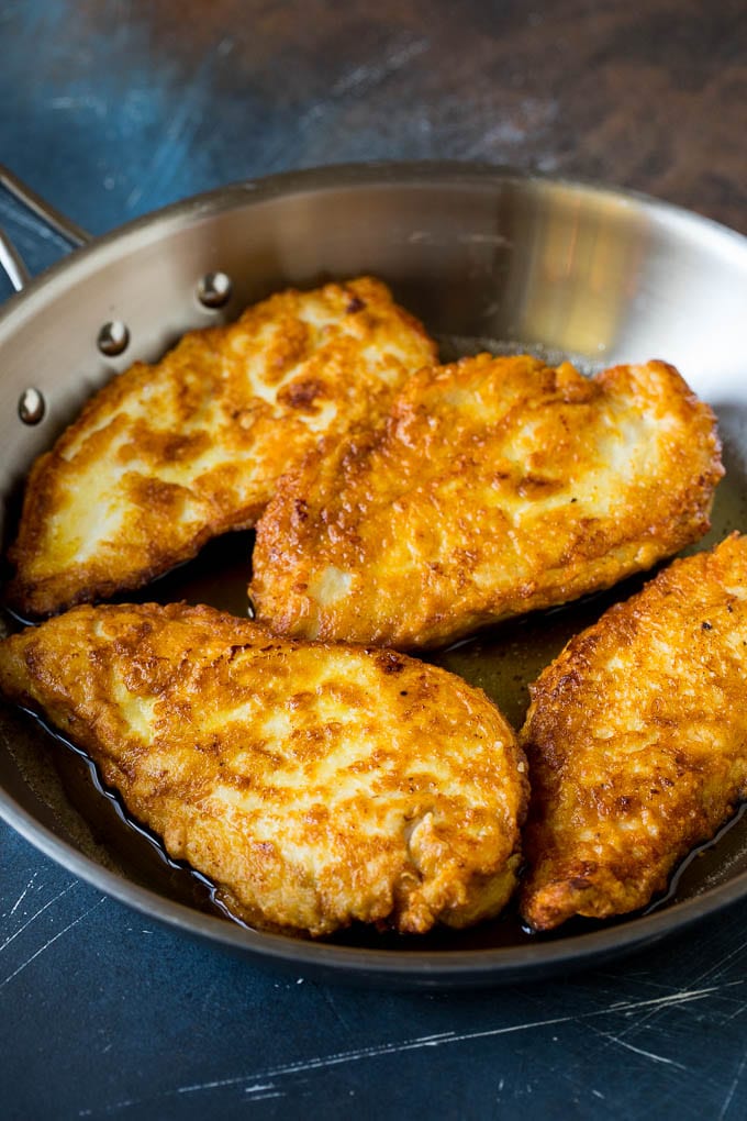 Chicken Francese Recipe #chicken #lemon #dinner #uzhal Battered and pan fried chicken cutlets in a pan.