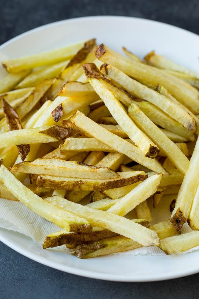 Homemade French Fries Recipe #potatoes #fries #dinner #uzhal Par-fried potatoes on a plate.