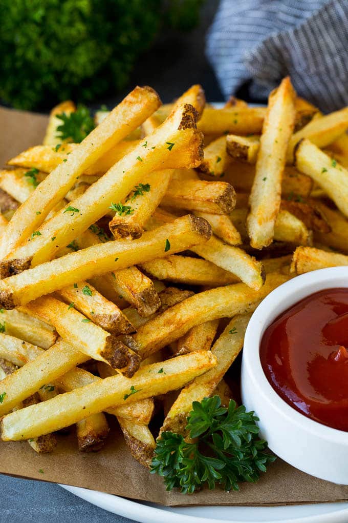 Homemade French Fries Recipe #potatoes #fries #dinner #uzhal A plate of homemade french fries served with a bowl of ketchup.