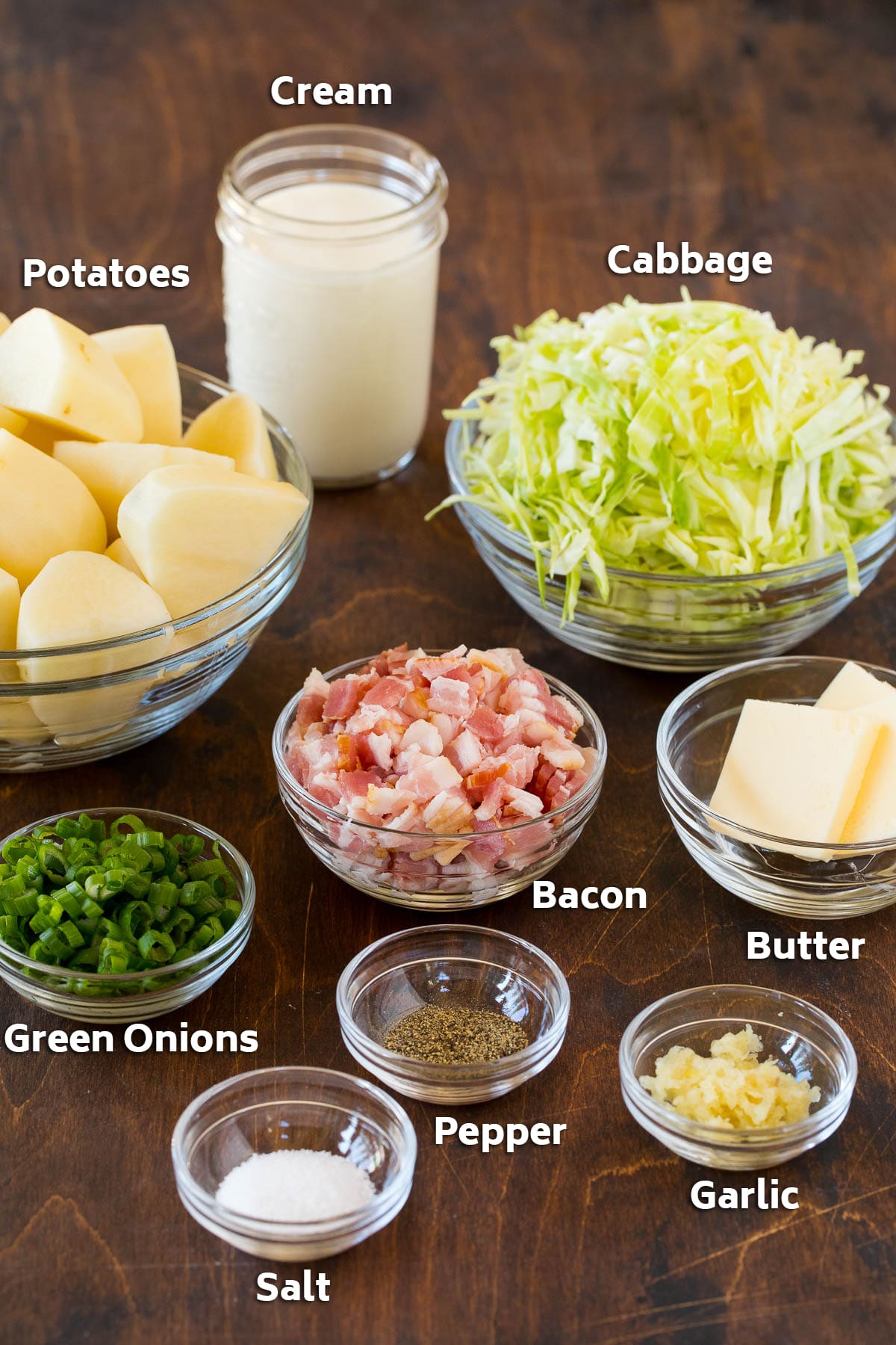 Colcannon Recipe | Mashed Potatoes #potatoes #cabbage #bacon #sidedish #stpatricksday #dinner #uzhal Bowls of bacon, cabbage, potatoes, and seasonings.