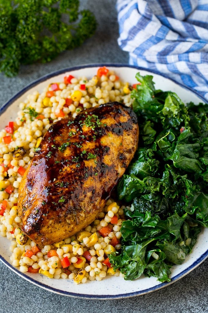 Sauteed kale flavored with olive oil and garlic, a quick and easy side dish! #kale #uzhal Grilled chicken served with a side of sauteed kale.