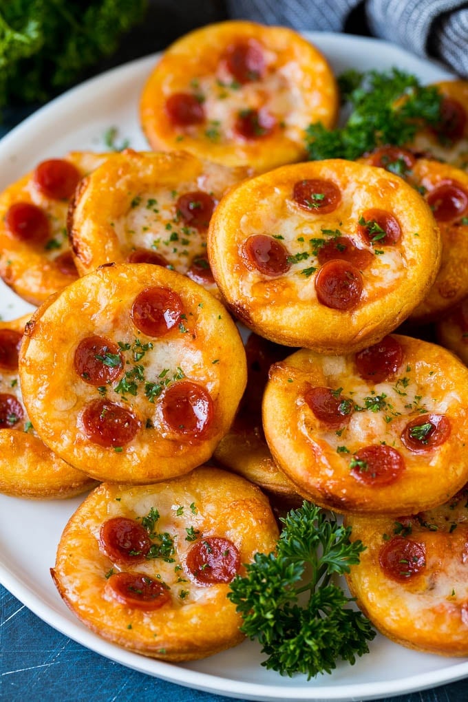 Mini pizzas topped with pepperoni are a fun and easy appetizer option. #pizza #uzhal #appetizer Mini pizzas topped with melted cheese and pepperoni.
