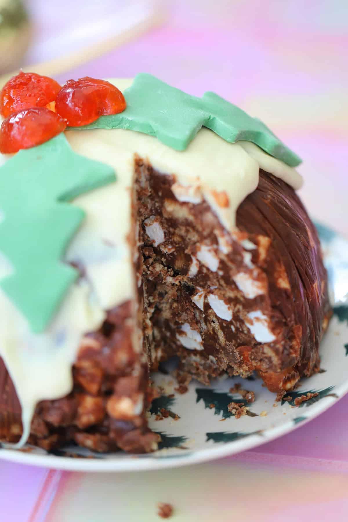 25+ Dolci Natalizi Senza Glutine 25 A Christmas pudding rocky road with a slice cut out of it.