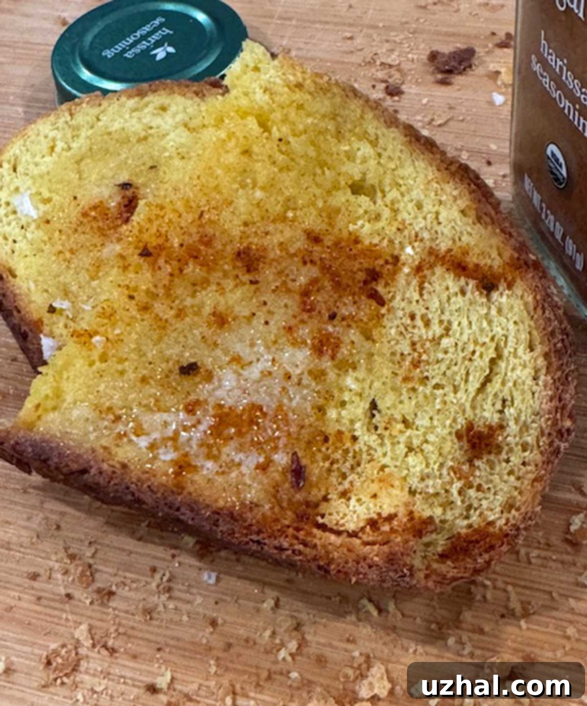 Crusty corn flour bread toast with butter and spicy harissa paste.