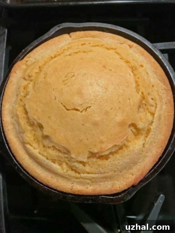 Cast iron skillet cornbread with a slice removed
