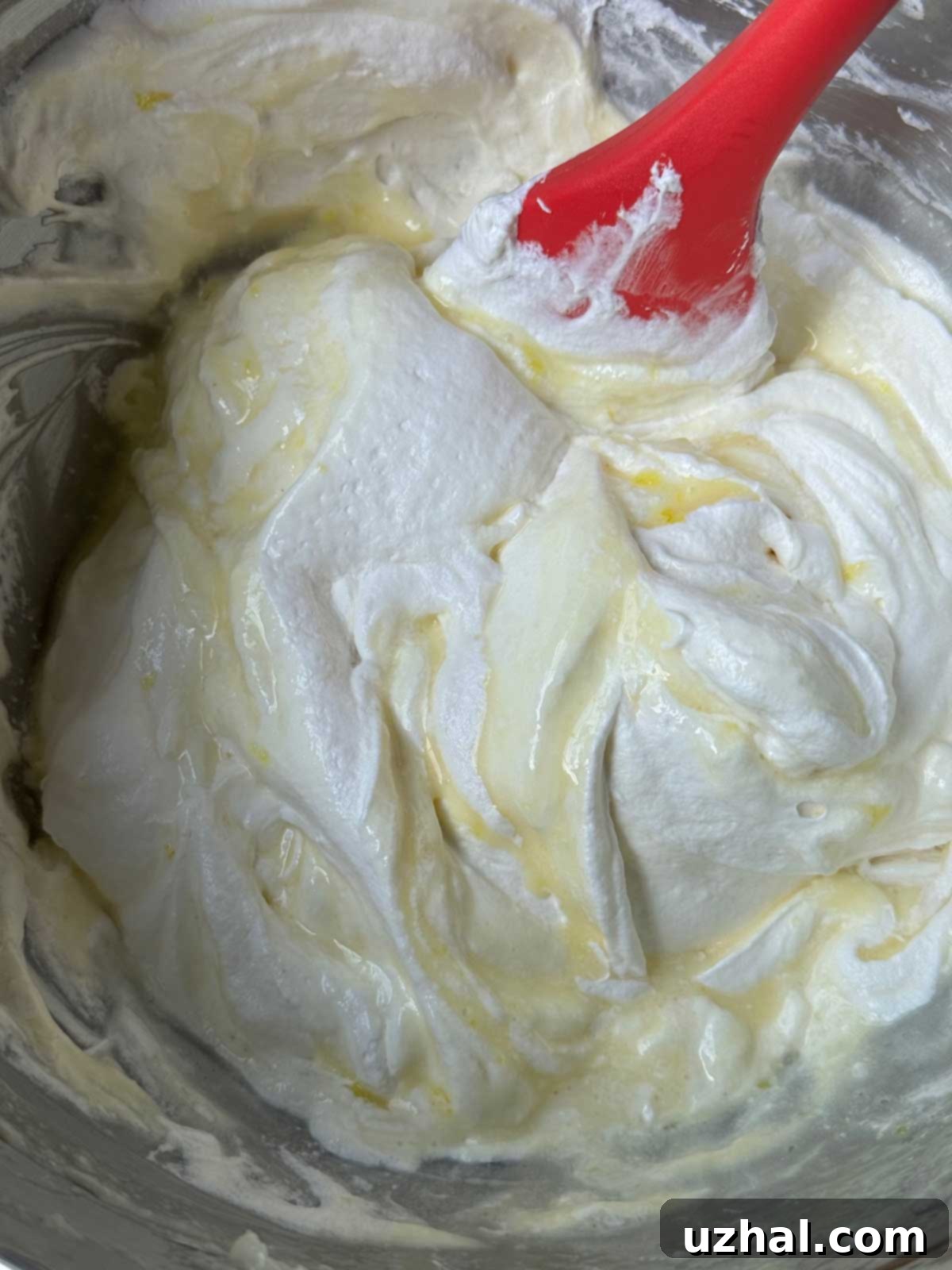 Cool Whip being folded into the filling for Woolworth's Cheesecake recipe.