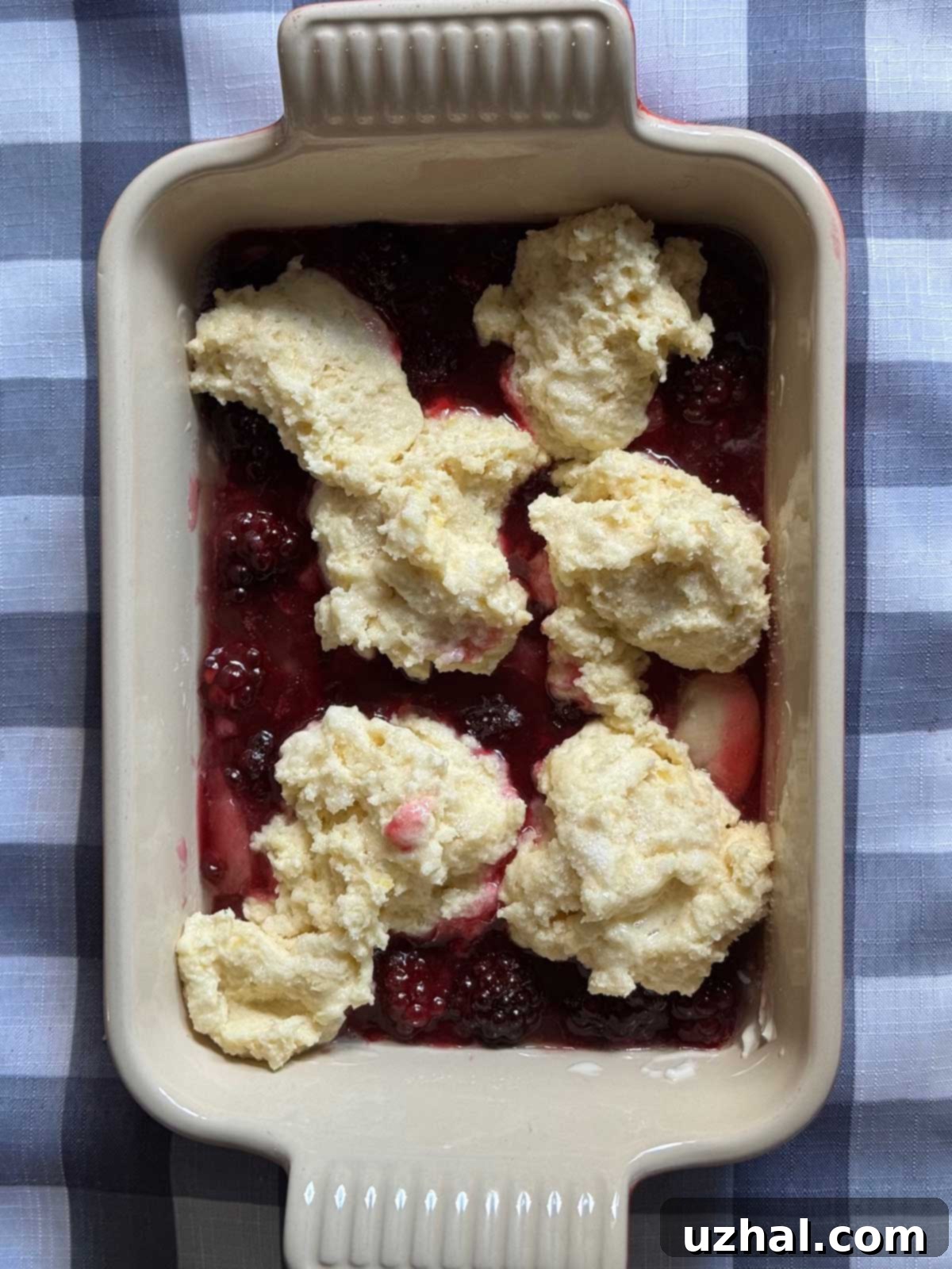 Quick Blackberry Cobbler recipe with uncooked biscuit topping, before being placed in the oven.