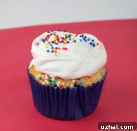 Beautifully frosted Angel Cupcakes with colorful sprinkles