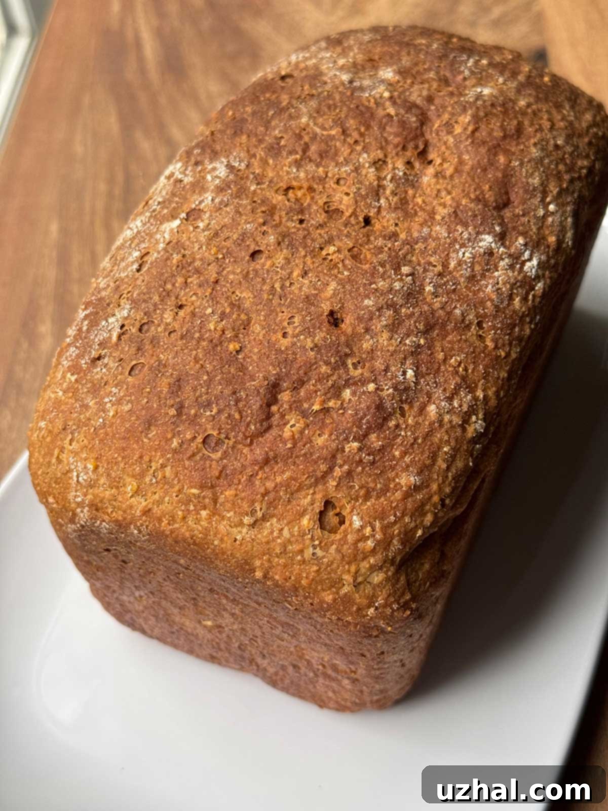 Loaf of Traditional Anadama Bread from a Boston recipe, showcasing its rustic crust and inviting color.