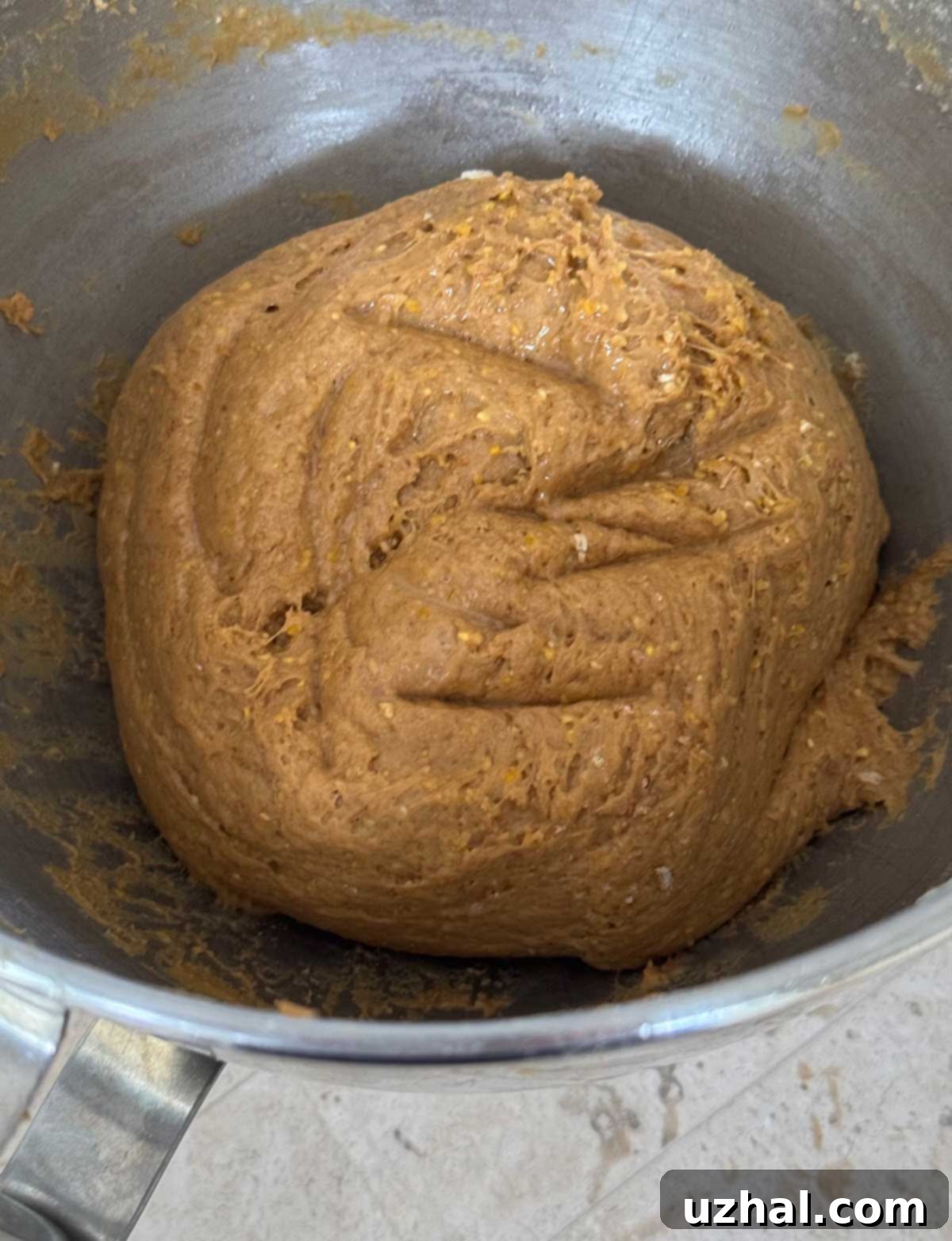 Anadama Bread dough in a mixing bowl, illustrating the correct sticky yet elastic consistency.