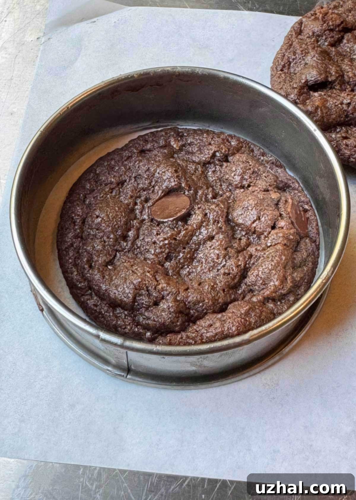 Chewy Vegan Double Chocolate Cookies being rounded using the cookie rounding trick with an English muffin ring for a perfect circular shape.