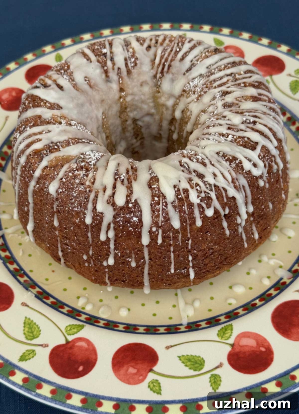 Apple Sour Cream Bundt Cake 3 An apple flavored Bundt cake with a dusting of powdered sugar and a confectioners' sugar frosting.