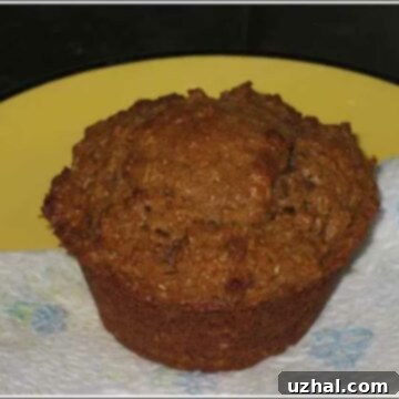 Freshly baked Sour Cream Bran Muffins on a cooling rack.