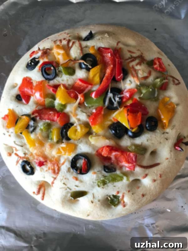 Small batch focaccia dough with various toppings, including peppers and olives