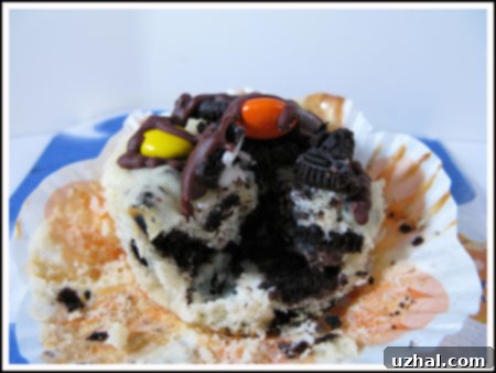 Oreo Mini Cheesecakes - small, individual cheesecakes featuring an Oreo cookie as the base, adorned with orange and black Halloween frosting.
