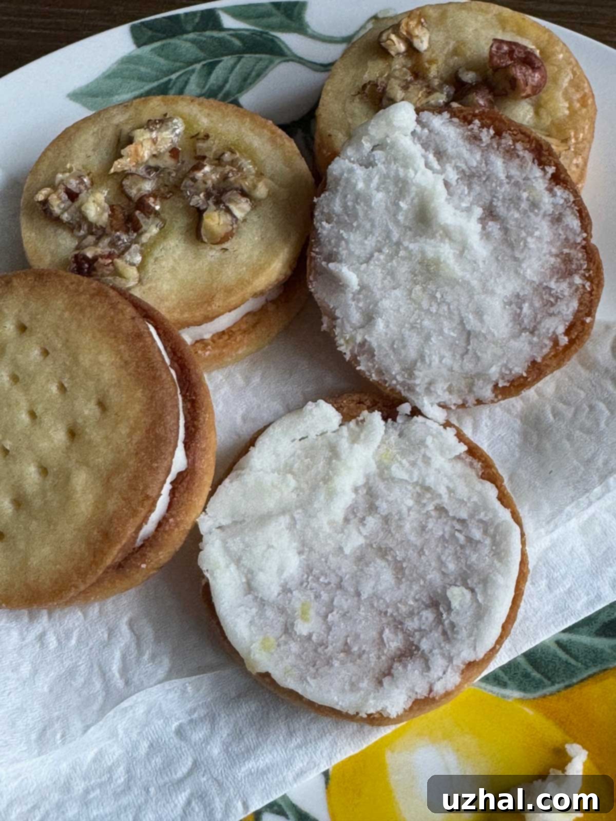 Close-up of a homemade Lemon-Filled Sandwich Cookie, split in half to reveal the creamy lemon filling and delicate shortbread cookie.