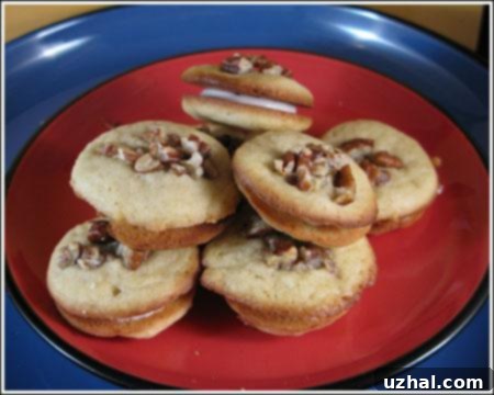 A plate of freshly baked homemade lemon sandwich cookies, ready to be assembled with a tangy filling.
