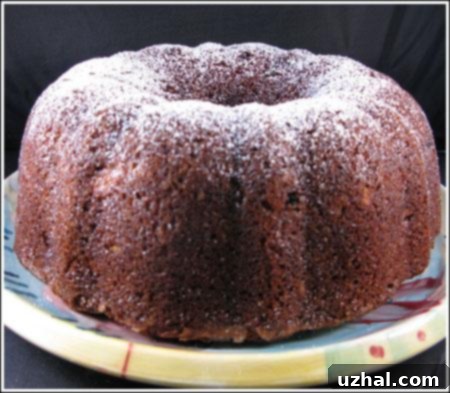 Close-up of a slice of Carrot Bundt Cake showing its moist crumb and visible carrot pieces