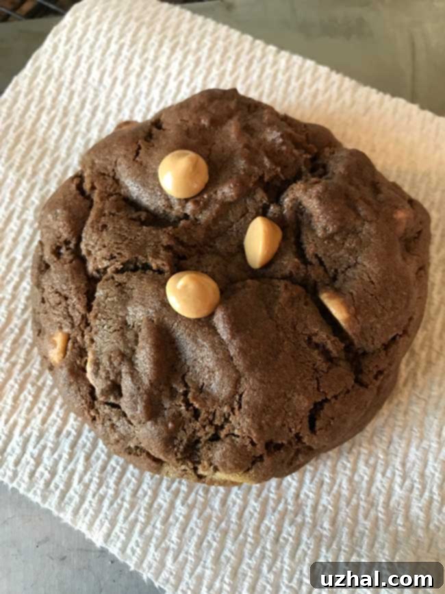 Freshly baked giant chocolate peanut butter chip cookies on a cooling rack