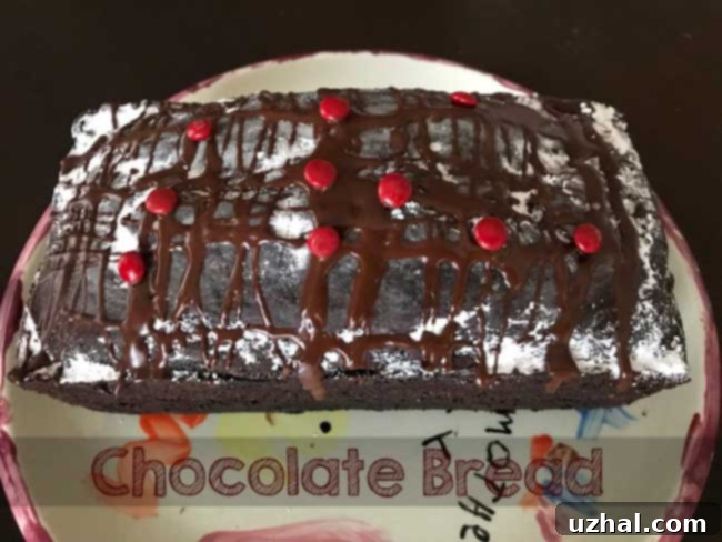 A freshly baked loaf of Buttermilk Chocolate Bread cooling on a wire rack.
