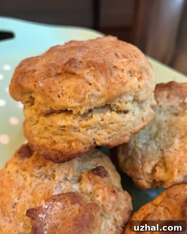 Freshly baked Angel Biscuits on a cooling rack, golden brown and fluffy.