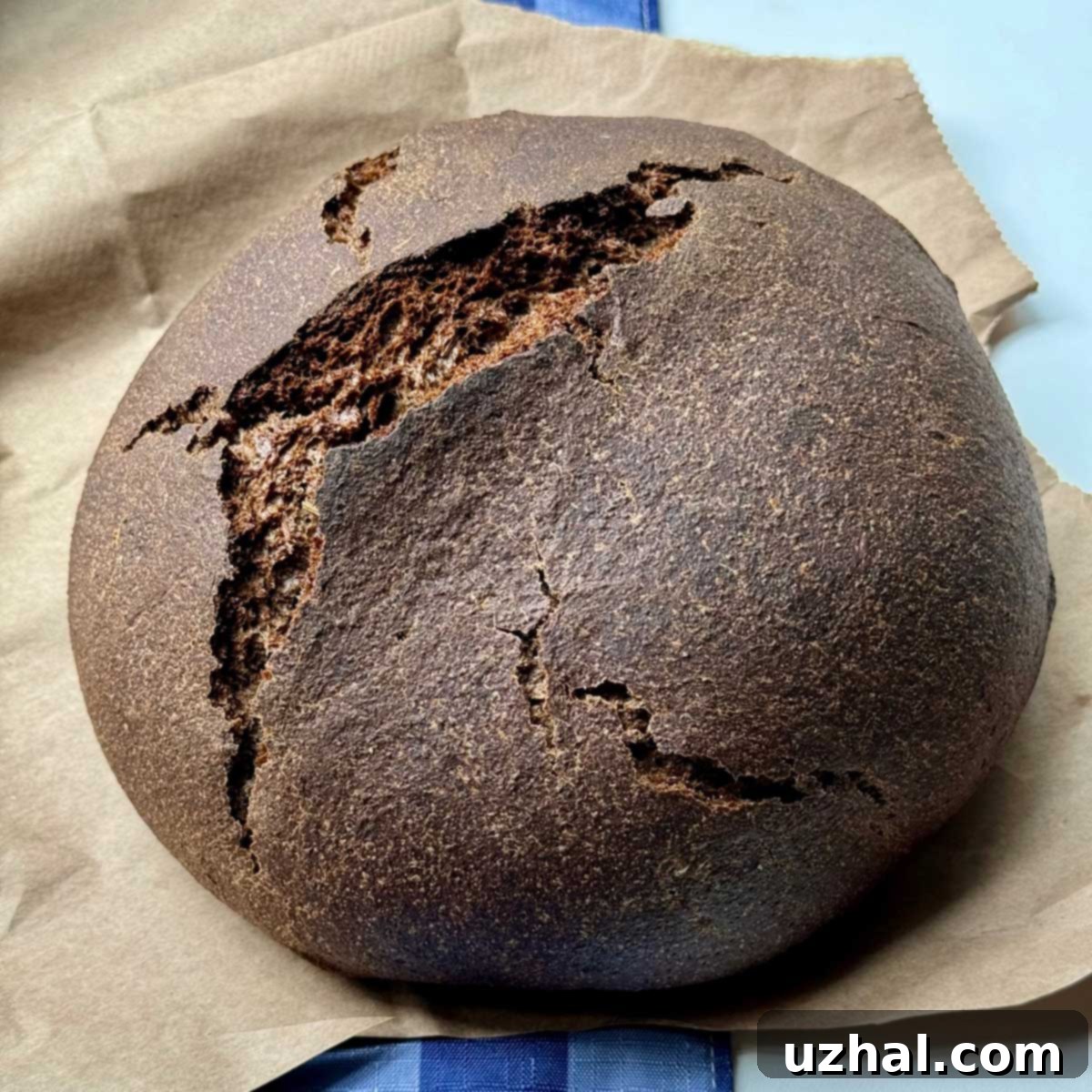 Dark Rye Bread, freshly baked loaf with a dark, rich crust, perfect for slicing.