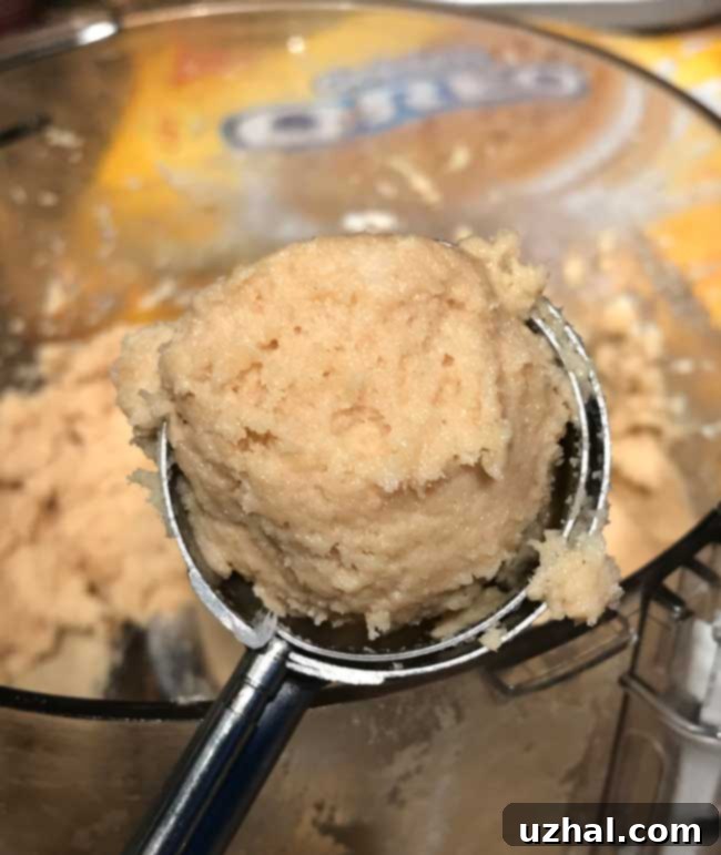 Golden Oreo Truffles mixture being processed in a food processor