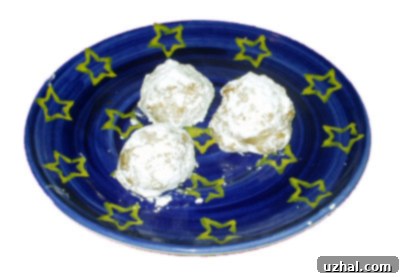 Several Chai Spiced Almond Cookies artfully arranged, highlighting their texture and sugar coating.