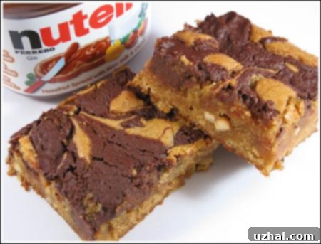 Close-up of a cut Marbled Nutella Peanut Butter Bar, showing the distinct layers and fudgy interior.