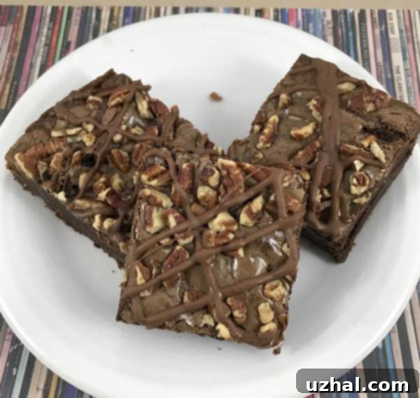 Bubbe's Famous Brownies, decked out with melted chocolate and crunchy pecans, ready to be served