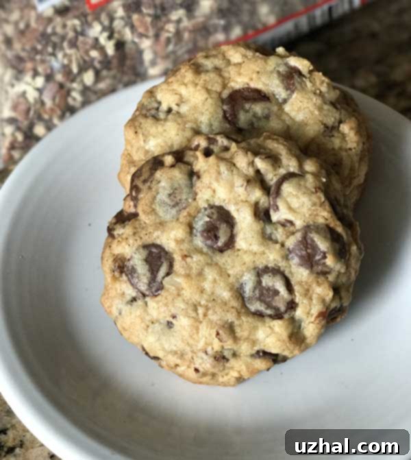 THOUGHTS: The user wants me to translate and "originalize" the provided Turkish title into English.
However, the provided title "Small Batch Chocolate Chip Pecan Coconut Cookies" is already in English. The instruction says: "Asagidaki Başlığı İngilizce çevir ve özgünleştir" which means "Translate the title below into English and make it original." If the given title is *already* English, then the "çevir" (translate) part is not applicable in the traditional sense. It might imply "rephrase" or "make it sound more engaging/unique." The original prompt:
"Asagidaki Başlığı İngilizce çevir ve özgünleştir, sadece 1 adet özgün başlığı ver çevirdiğin başlığı özel karakterler varsa sil ve özel karakter ekleme * gibi ve İşte özgün başlık: gibi cümleler kurmadan, sadece başlığı yaz.
Small Batch Chocolate Chip Pecan Coconut Cookies" Let's break down the rules:
1. **Translate to English and make it original:** The input is already English. So, the task is to make it original/more engaging, while keeping the core meaning.
2. **Only 1 original title:** Provide only one output.
3. **Remove special characters from the *translated* title if any, and don't add special characters:** The input has no special characters. The output should also not have any.
4. **No introductory phrases like "İşte özgün başlık:"**: Just the title itself. The core request is to "özgünleştir" (make it original/unique) from the given "Small Batch Chocolate Chip Pecan Coconut Cookies." What makes a title original or engaging?
* Adding descriptive adjectives (e.g., "Gourmet," "Irresistible," "Decadent")
* Focusing on a key characteristic (e.g., "Mini," "Homemade")
* Creating a more evocative phrase.
* Slightly reordering or emphasizing components. Let's brainstorm some options for "Small Batch Chocolate Chip Pecan Coconut Cookies": * *Too similar:* Small Batch Pecan Coconut Chocolate Chip Cookies (just reordered)
* *Adding a descriptor:* Decadent Small Batch Chocolate Pecan Coconut Bites
* *Focusing on taste/experience:* Irresistible Small Batch Pecan Coconut Chocolate Treats
* *More concise/catchy:* Chocolate Pecan Coconut Bites (loses "small batch" unless implied by "bites")
* *Emphasizing homemade/comfort:* Cozy Small Batch Chocolate Pecan Coconut Cookies
* *Slightly more sophisticated:* Artisanal Small Batch Chocolate Pecan Coconut Cookies
* *Playing on "batch":* A Perfect Batch: Chocolate Pecan Coconut Cookies
* *Highlighting texture/flavor:* Chewy Chocolate Pecan Coconut Cookies (might not be accurate if not specified)
* *A bit more active:* Bake a Small Batch of Chocolate Pecan Coconut Cookies (too long, more of a call to action) The original title "Small Batch Chocolate Chip Pecan Coconut Cookies" is very descriptive and functional. "Originalizing" it means giving it a bit more flair or a specific angle, without losing the core information (chocolate chip, pecan, coconut, cookies, small batch). Let's try to keep "Small Batch" as it's a defining characteristic. Option 1: Elevate "small batch" and the ingredients.
"Gourmet Small Batch Chocolate Pecan Coconut Cookies" - "Gourmet" adds a sense of quality/originality. Option 2: Focus on the appeal.
"Irresistible Small Batch Chocolate Pecan Coconut Treats" - "Irresistible" adds allure, "Treats" is a broader term than cookies but works. Option 3: Make it sound more homemade/cozy.
"Cozy Small Batch Chocolate Pecan Coconut Cookies" Option 4: A slightly more elegant phrasing.
"Handcrafted Small Batch Chocolate Pecan Coconut Cookies" Considering the instructions, the goal is "özgünleştir" which means to make it unique or original. Simply adding an adjective like "Gourmet" or "Irresistible" is a good way to do this without changing the fundamental meaning or length too much. Let's choose one that sounds appealing and distinct from the very functional original.
"Small Batch Chocolate Chip Pecan Coconut Cookies" If I were to pick one that adds a touch of uniqueness and appeal:
"Decadent Small Batch Chocolate Pecan Coconut Cookies"
"Irresistible Small Batch Chocolate Pecan Coconut Cookies"
"Gourmet Small Batch Chocolate Pecan Coconut Cookies" I will go with "Decadent" as it evokes a rich, indulgent experience, which is suitable for cookies of this type. It's concise and adds a strong positive descriptor. It doesn't use any special characters. It's a single title. Final check:
- Translate/Originalize: Yes, originalizing the existing English title.
- 1 title: Yes.
- No special characters: Yes.
- No intro phrases: Yes.
- Just the title: Yes. 2 Delicious small batch chocolate chip pecan coconut cookies arranged on a baking sheet, showcasing their chewy texture and crispy edges.