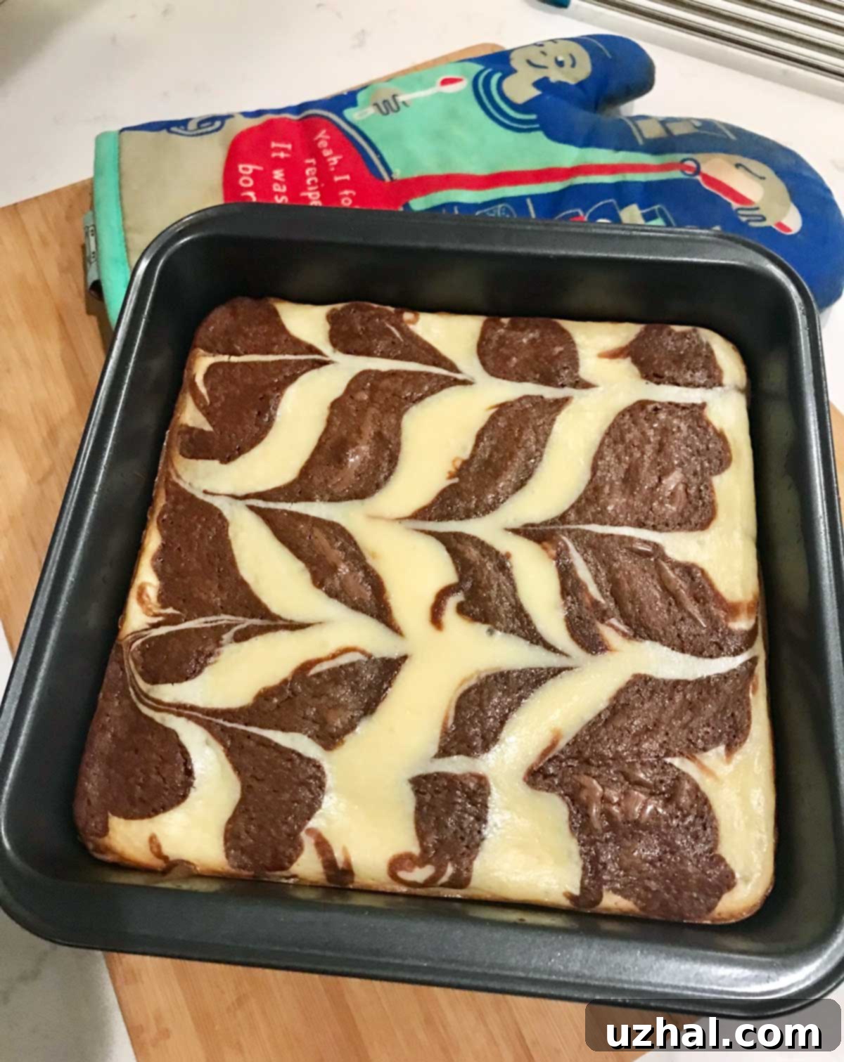 Decadent Cream Cheese Swirl Brownies, freshly baked and adorned with a beautiful marbled top, ready to be enjoyed as a luxurious homemade dessert.